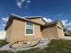 Charming single-story home with beige stucco exterior and decorative rock landscaping at 299 Chicago W Ave, Haines City, FL 33844