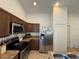 Kitchen boasting stainless steel appliances, tile flooring, and wood cabinetry at 299 Chicago W Ave, Haines City, FL 33844