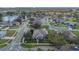 Aerial view of the community showing lush landscape, mature trees and serene lake at 3050 Grasmere View Pkwy, Kissimmee, FL 34746