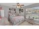 Bedroom with a ceiling fan and a large window allowing natural light to enter the space at 3050 Grasmere View Pkwy, Kissimmee, FL 34746