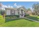 Landscaped front yard featuring lush lawn and decorative shrubs around a well-maintained home at 3050 Grasmere View Pkwy, Kissimmee, FL 34746