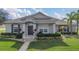 Charming single-story home with well-manicured lawn and inviting entryway at 3050 Grasmere View Pkwy, Kissimmee, FL 34746