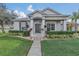 Charming single-story home with meticulously manicured front lawn, walkway, and mature landscaping at 3050 Grasmere View Pkwy, Kissimmee, FL 34746