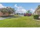 Expansive front lawn of home showing meticulous landscaping and beautiful trees along the street at 3050 Grasmere View Pkwy, Kissimmee, FL 34746