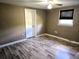 Comfortable bedroom featuring laminate wood flooring, a ceiling fan, and a closet at 306 W Palm St, Davenport, FL 33837