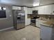 Modern kitchen featuring stainless steel appliances, granite countertops, and ample cabinet space at 306 W Palm St, Davenport, FL 33837