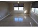 Bright living room with tile floors and lots of natural light from the large windows at 306 W Palm St, Davenport, FL 33837