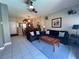 Bright living room featuring tile floors, neutral paint, furniture, and an adjacent dining area at 3136 Yellow Lantana Ln, Kissimmee, FL 34747