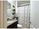 Bright bathroom featuring a vanity with granite countertop and a shower with a themed curtain at 3211 Surfbird St, Kissimmee, FL 34744