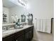 Bathroom vanity with double sinks, granite countertops and decorative mirror at 3211 Surfbird St, Kissimmee, FL 34744