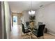 Light and bright dining area features a glass-topped table set for four, tile flooring, and neutral paint at 3211 Surfbird St, Kissimmee, FL 34744