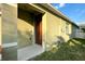 Close up of a charming single-Gathering home's entryway door and manicured lawn at 3211 Surfbird St, Kissimmee, FL 34744