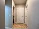 Hallway featuring neutral paint, tiled floors, and doorways leading to other rooms at 3211 Surfbird St, Kissimmee, FL 34744