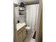 This bathroom features a sleek vanity, toilet, shower and decorative shelving at 3240 S Semoran Blvd # 14, Orlando, FL 32822