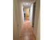 Hallway with brown tile flooring and white walls that leads to a living area at 3240 S Semoran Blvd # 14, Orlando, FL 32822