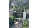 Inviting condo exterior with lush landscaping, stone walkway, and stairs to the upper level at 3240 S Semoran Blvd # 14, Orlando, FL 32822