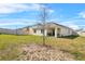 View of the home's spacious fenced backyard, showcasing the outdoor space and landscaping at 33436 Country House Dr, Sorrento, FL 32776