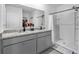 Bathroom with double sink vanity with granite countertop and a walk-in shower at 33436 Country House Dr, Sorrento, FL 32776