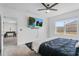 Stylish bedroom featuring a ceiling fan, flat screen television, and ample natural light at 33436 Country House Dr, Sorrento, FL 32776