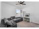 Comfortable bedroom featuring a gray sectional sofa, a makeup vanity, and a large window for natural light at 33436 Country House Dr, Sorrento, FL 32776