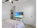 Bedroom showcasing a neutral color scheme, a view into the hallway, and a modern television on a dresser at 33436 Country House Dr, Sorrento, FL 32776