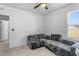 Bright bedroom with gray upholstered sofa and a ceiling fan for added comfort at 33436 Country House Dr, Sorrento, FL 32776