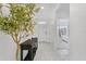 Bright foyer featuring neutral tile flooring, a stylish console table, and an inviting view into other rooms at 33436 Country House Dr, Sorrento, FL 32776