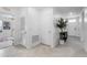 Hallway displaying neutral tile flooring and white doors with a view of the foyer and another room at 33436 Country House Dr, Sorrento, FL 32776