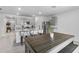 Kitchen and dining area with granite countertops, stainless steel appliances, a kitchen island, and gray cabinets at 33436 Country House Dr, Sorrento, FL 32776