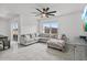 Bright living room with a ceiling fan, sliding door, and lots of natural light at 33436 Country House Dr, Sorrento, FL 32776