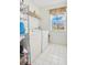 Functional laundry room features a washer, dryer, shelving, and natural light at 3452 Goldeneye Ln, St Cloud, FL 34772