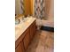 Bathroom with double sink vanity and a shower with blue decorative accents at 350 Corsica Ct, Kissimmee, FL 34758