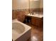 Bathroom featuring a bathtub and vanity with dual sinks at 350 Corsica Ct, Kissimmee, FL 34758