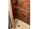 Bathroom shower with brown decorative tile and white shower base at 350 Corsica Ct, Kissimmee, FL 34758