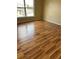 Bedroom featuring wood floors and a large window letting in lots of natural light at 350 Corsica Ct, Kissimmee, FL 34758
