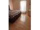 Cozy bedroom featuring wood floors and a patterned comforter at 350 Corsica Ct, Kissimmee, FL 34758