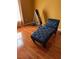Bright bedroom featuring sleek hardwood floors, a modern chaise lounge, and exercise equipment at 350 Corsica Ct, Kissimmee, FL 34758