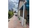 Exterior view showing the side of the home with green foliage, an air conditioning unit and a covered patio at 350 Corsica Ct, Kissimmee, FL 34758