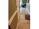 Hallway featuring light-colored tile flooring, a textured rug, and neutral-colored walls with white trim at 350 Corsica Ct, Kissimmee, FL 34758