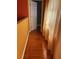 Hallway featuring wood floors and natural light streaming through the curtains at 350 Corsica Ct, Kissimmee, FL 34758