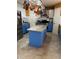 Bright kitchen with blue cabinets, granite countertops, stainless steel appliances, and an island at 350 Corsica Ct, Kissimmee, FL 34758