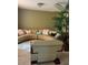Living room with a beige sectional sofa, accent pillows, and a tall potted plant at 350 Corsica Ct, Kissimmee, FL 34758
