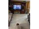 Open living area featuring a large entertainment center, tile floors, and ample seating at 350 Corsica Ct, Kissimmee, FL 34758