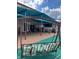 Covered patio area featuring a swing, outdoor kitchen area, and access to the house through glass doors at 350 Corsica Ct, Kissimmee, FL 34758