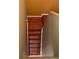 A staircase with hardwood steps, painted walls, and a yellow ceiling at 350 Corsica Ct, Kissimmee, FL 34758