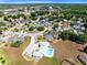 Wide aerial shot of the neighborhood, showing residential streets and nearby amenities like a pool at 3741 Crossing Creek Blvd, St Cloud, FL 34772