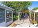 Backyard patio area with shaded seating, privacy fence, and partial view of the home at 3741 Crossing Creek Blvd, St Cloud, FL 34772