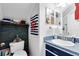 Nautical-themed bathroom with blue accents, a clean vanity, and a mirrored cabinet at 3741 Crossing Creek Blvd, St Cloud, FL 34772