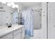 Well-lit bathroom with white vanity, tub-shower combination, and decorative elements, designed for functionality and style at 3741 Crossing Creek Blvd, St Cloud, FL 34772