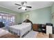 Bright bedroom featuring wood floors, fan and sliding doors, with view to screened lanai providing a serene living space at 3741 Crossing Creek Blvd, St Cloud, FL 34772